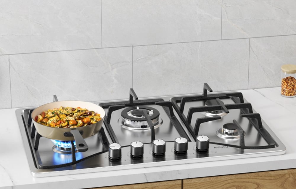 IsEasy gas hob with beige pan with food on blue flame in white kitchen