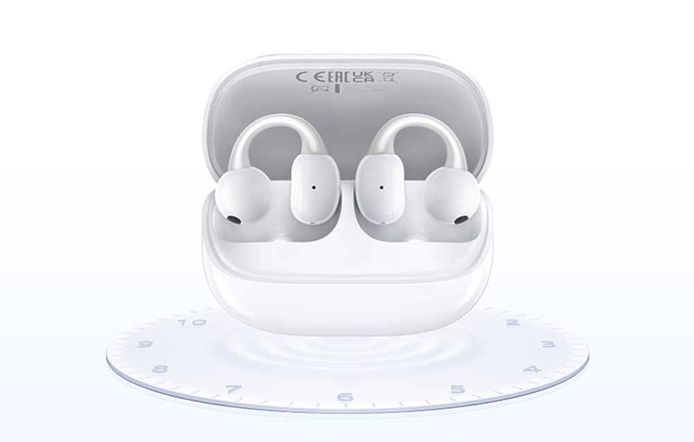 White wireless headphones with headband are in the open charging case