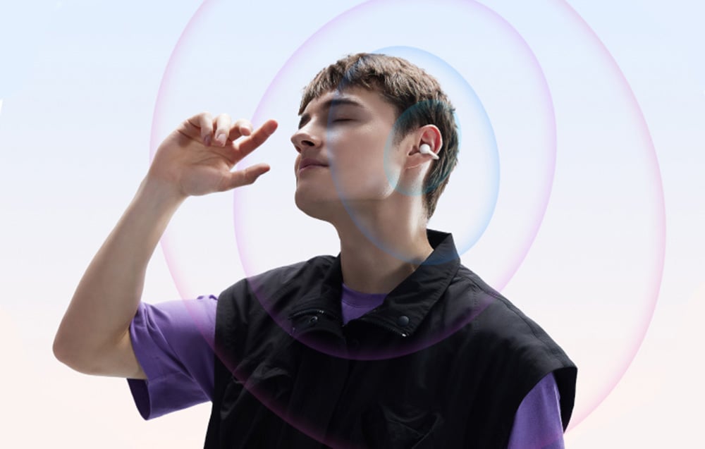 Man with closed eyes wearing wireless earbuds, surrounded by colorful sound waves