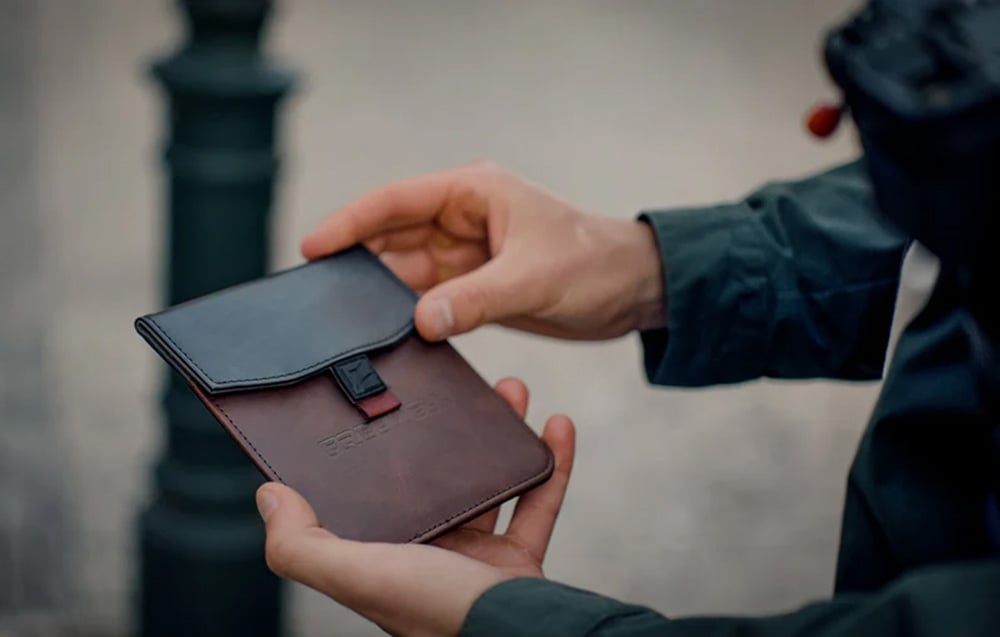 Holding a black and brown Freewell filter case.