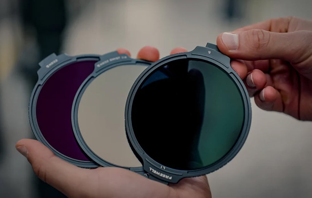 Holding 3 photo filters in your hands.