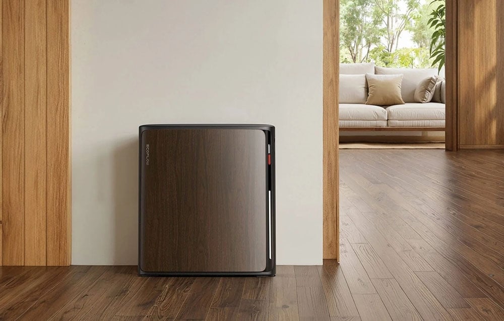 Energy storage with wooden finish standing against a wall in a bright interior overlooking the living room