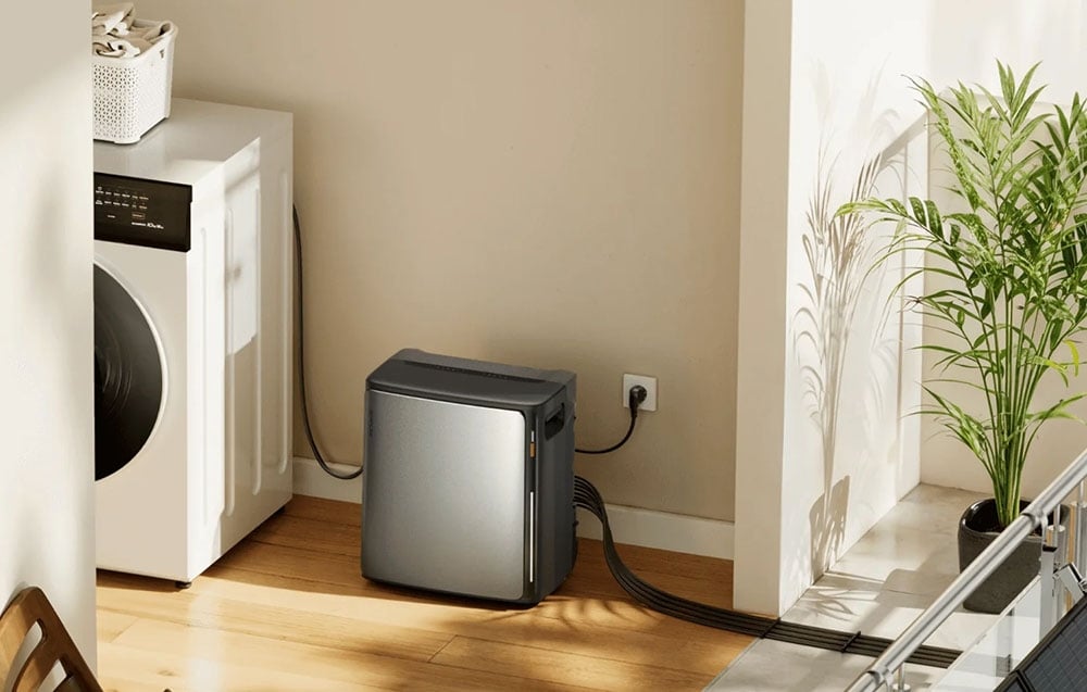 Energy storage connected to an outlet in a room with a washing machine and a potted plant