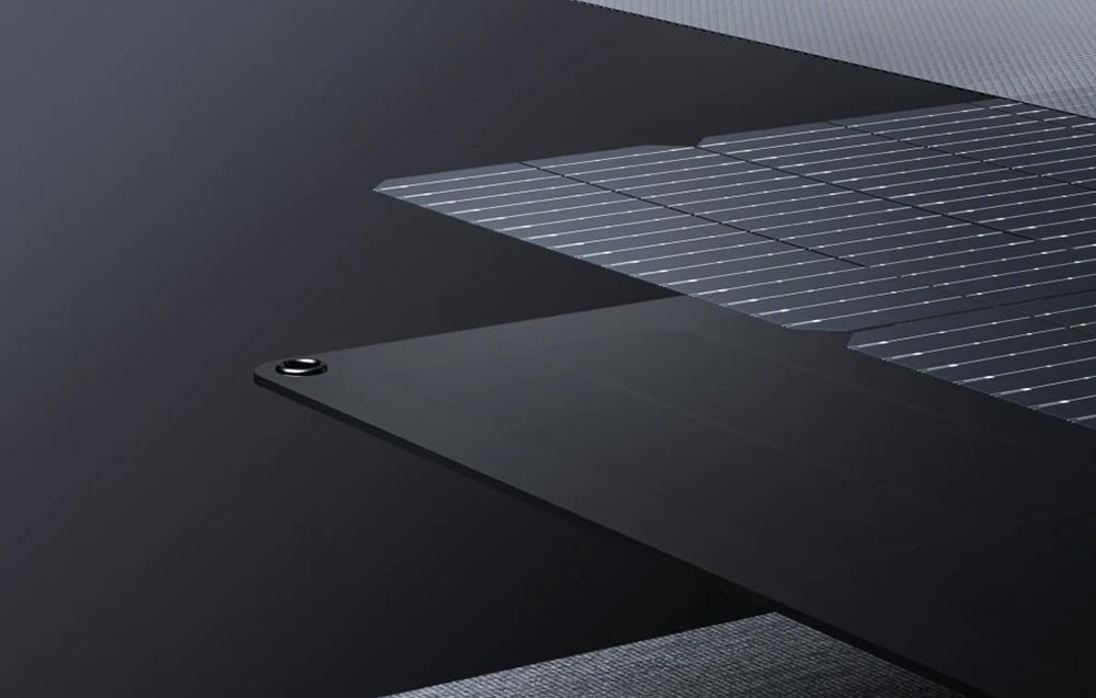 Close-up of photovoltaic panel layers with visible cells and mounting hole on a dark background
