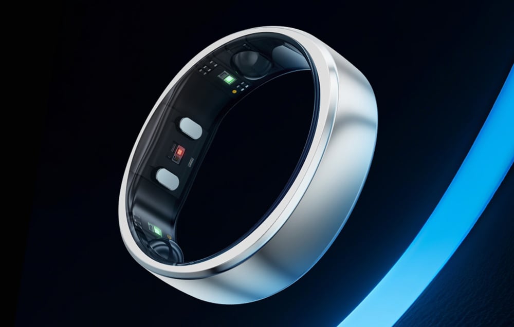Close-up of a silver ring with visible sensors, shown against a dark background with a blue glow
