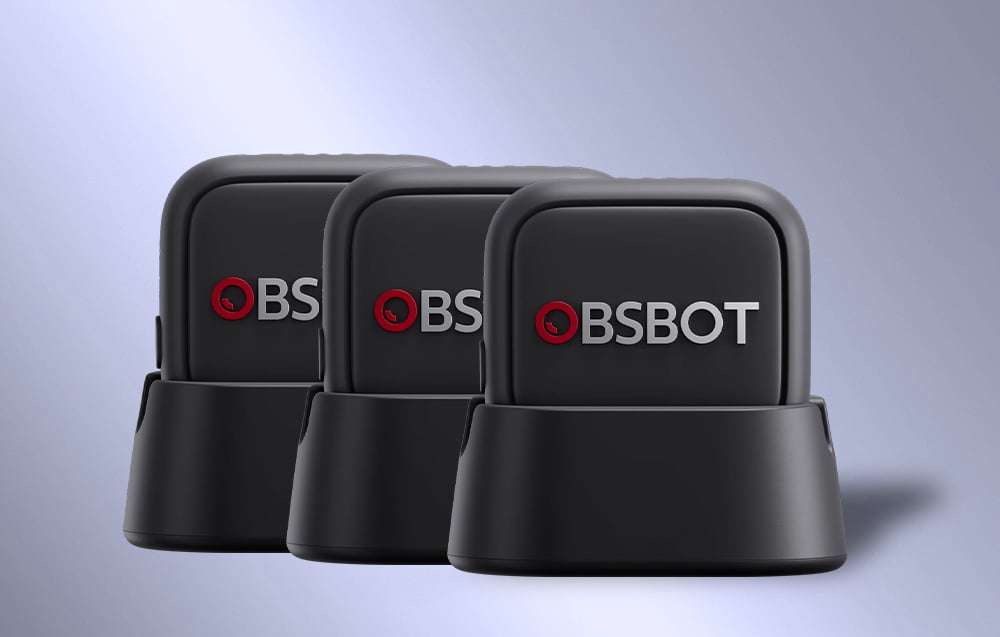 Three OBSBOT microphones lined up on charging stands, showcasing consistent design and branding