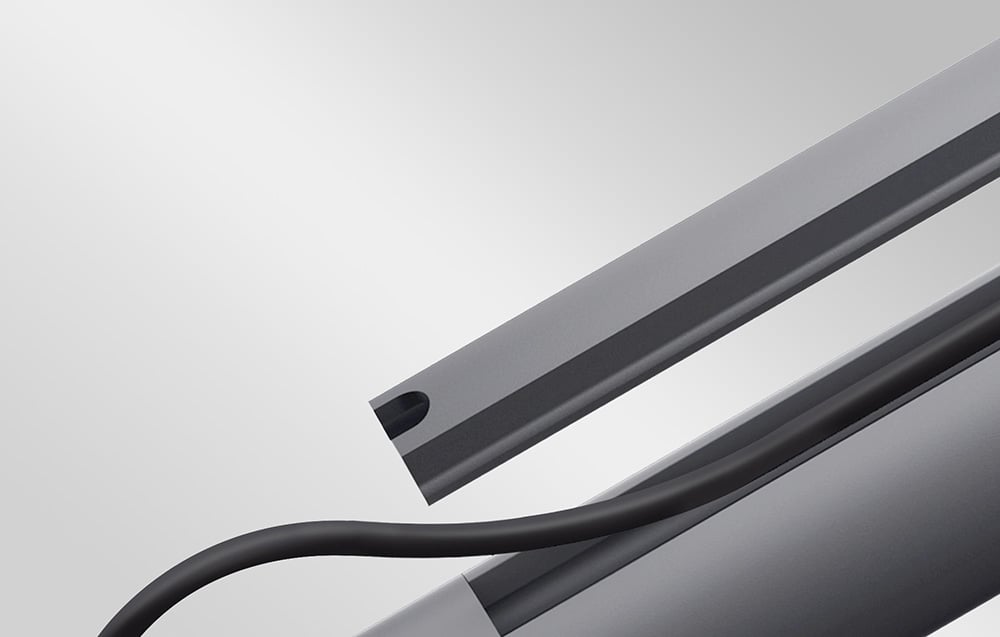 Close-up of the side profile of the mount with a visible opening and an aesthetically routed black cable.