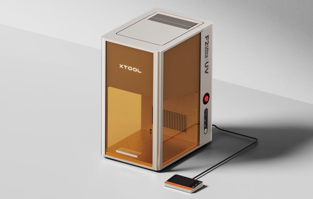 xTool F2 Ultra UV laser engraver with closed cover, control panel and cable on a gray background