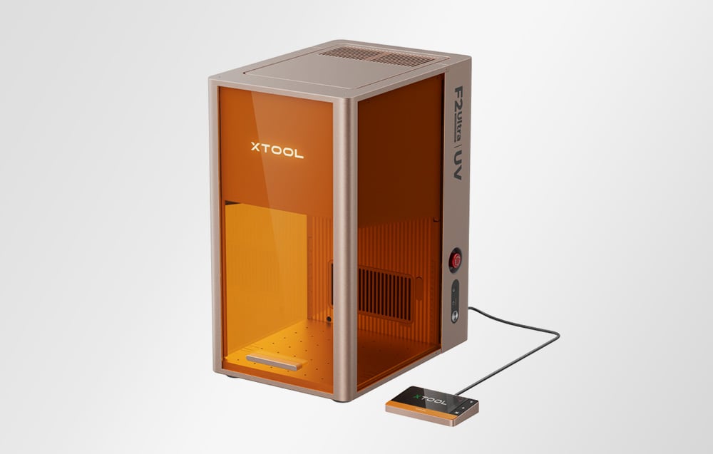 xTool F2 Ultra UV laser engraving machine on a gray background