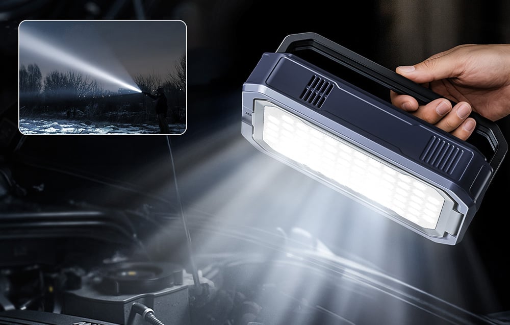 A car jump starter used as a powerful flashlight to illuminate the engine under the hood.