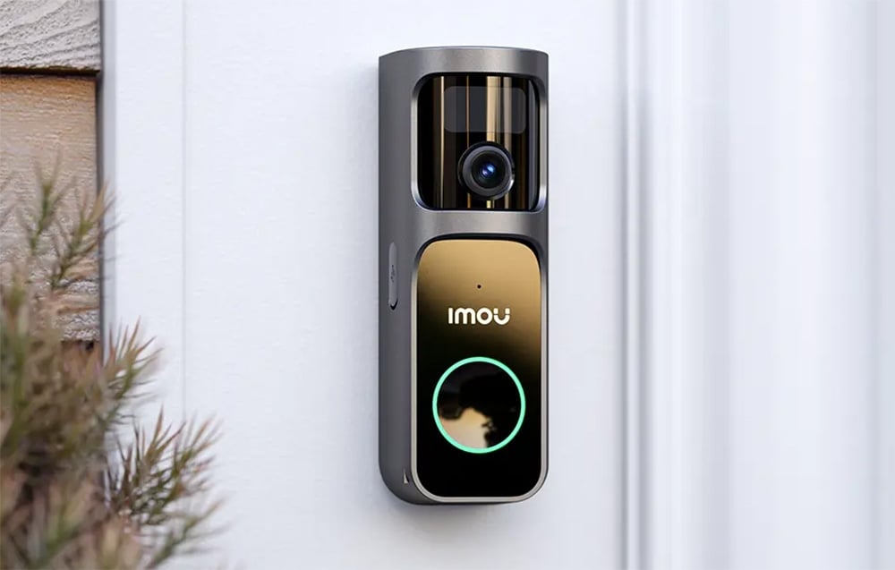 Silver and black Imou video intercom with lens and green backlit button against a white wall