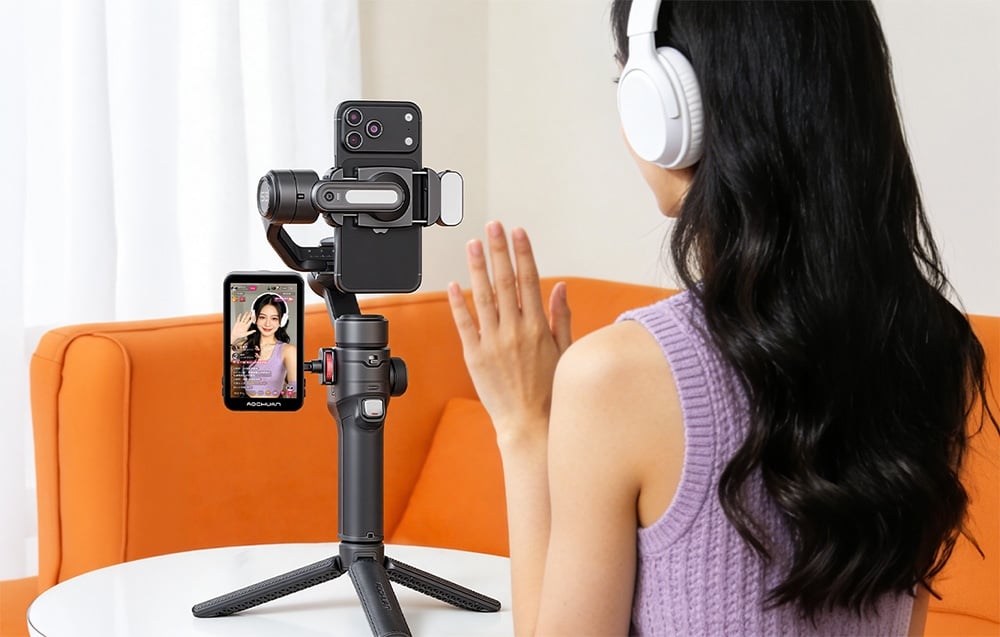 A woman wearing headphones is live-streaming using an Aochuan gimbal on a tripod
